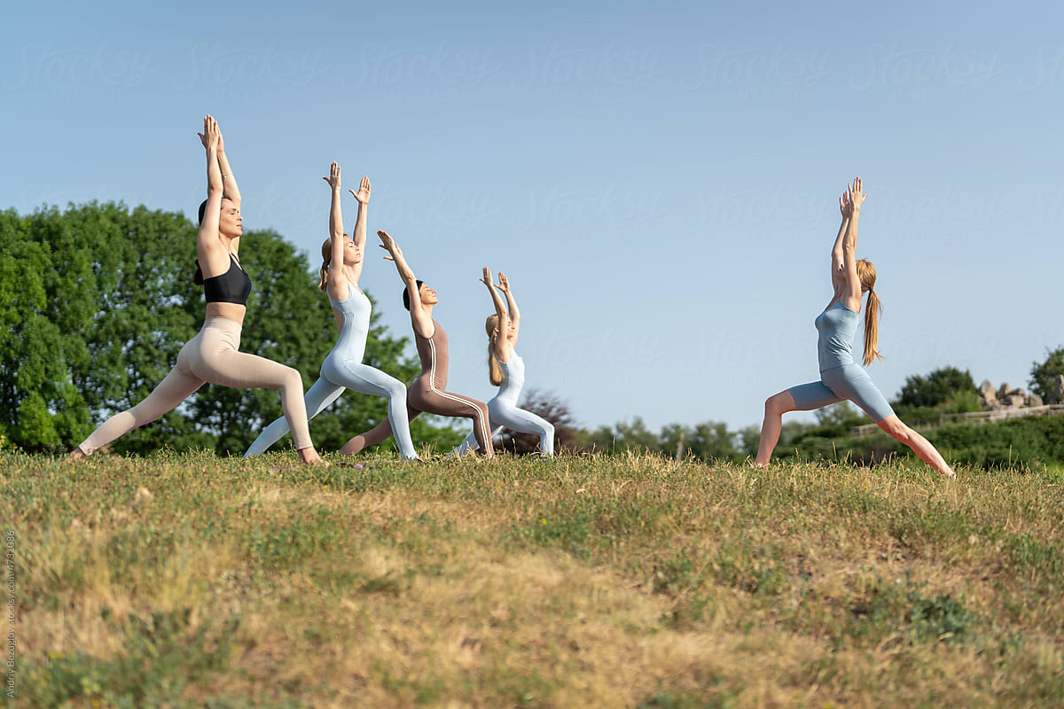 Group of young sporty woman practicing yoga lesson