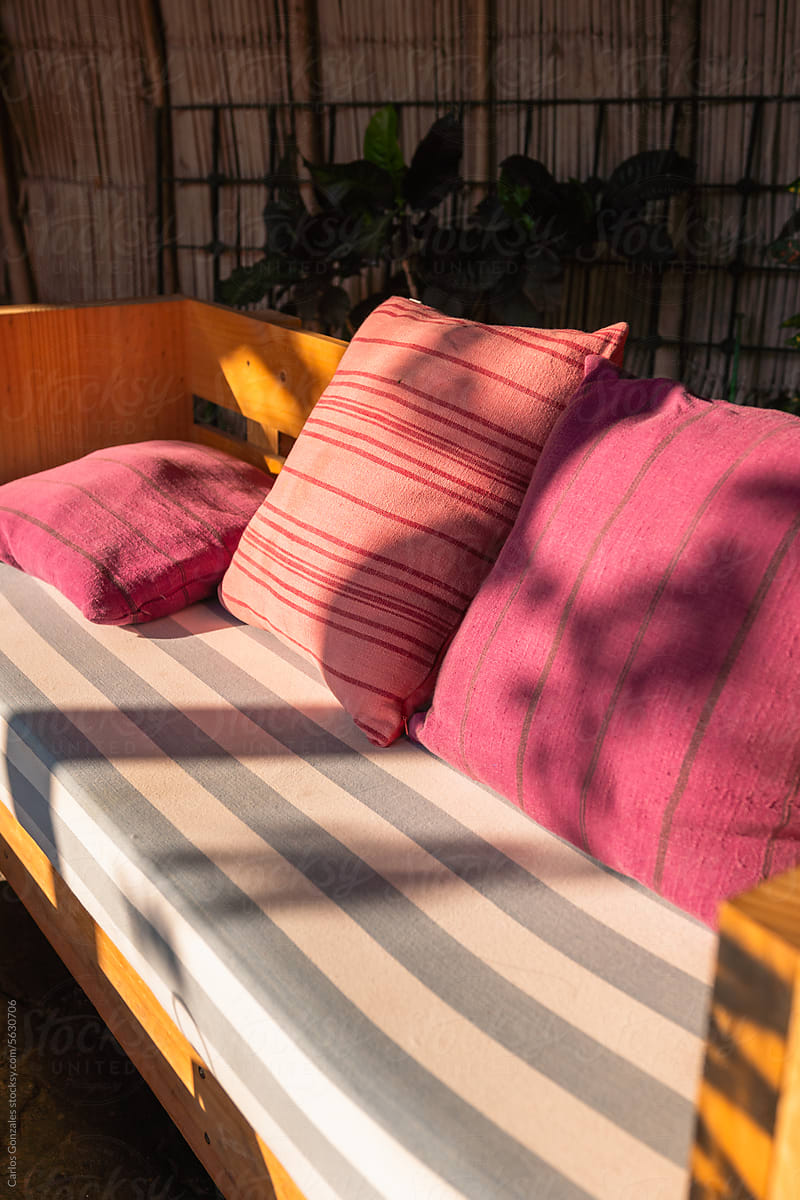 Beautiful light on a couch with pink pillows