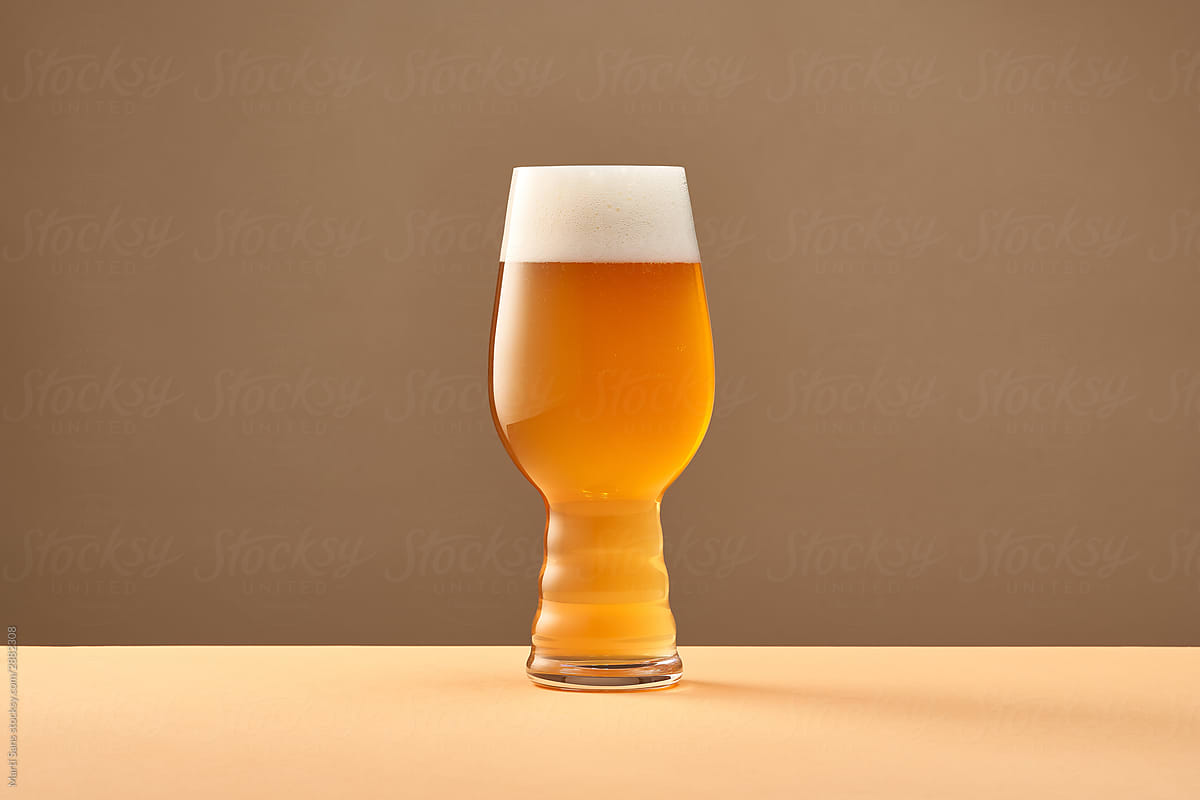 Cup with cold beer on table