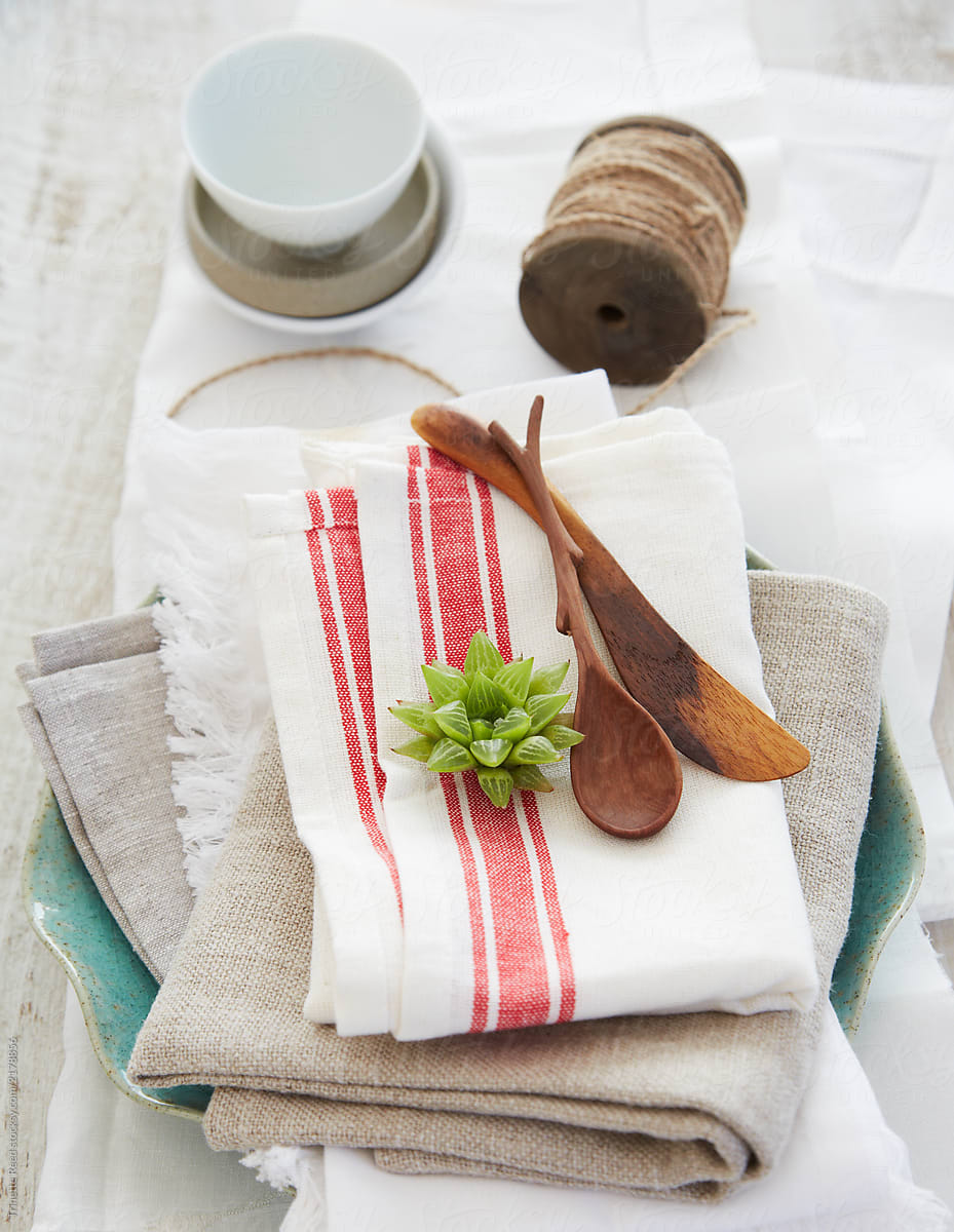 Stack of linens with wood utensils