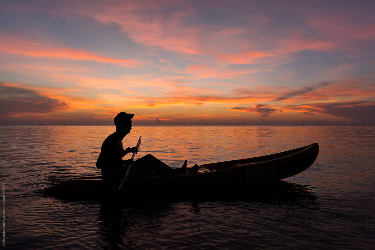 Anonymous Man In Kayak Watching Beautiful Sunset