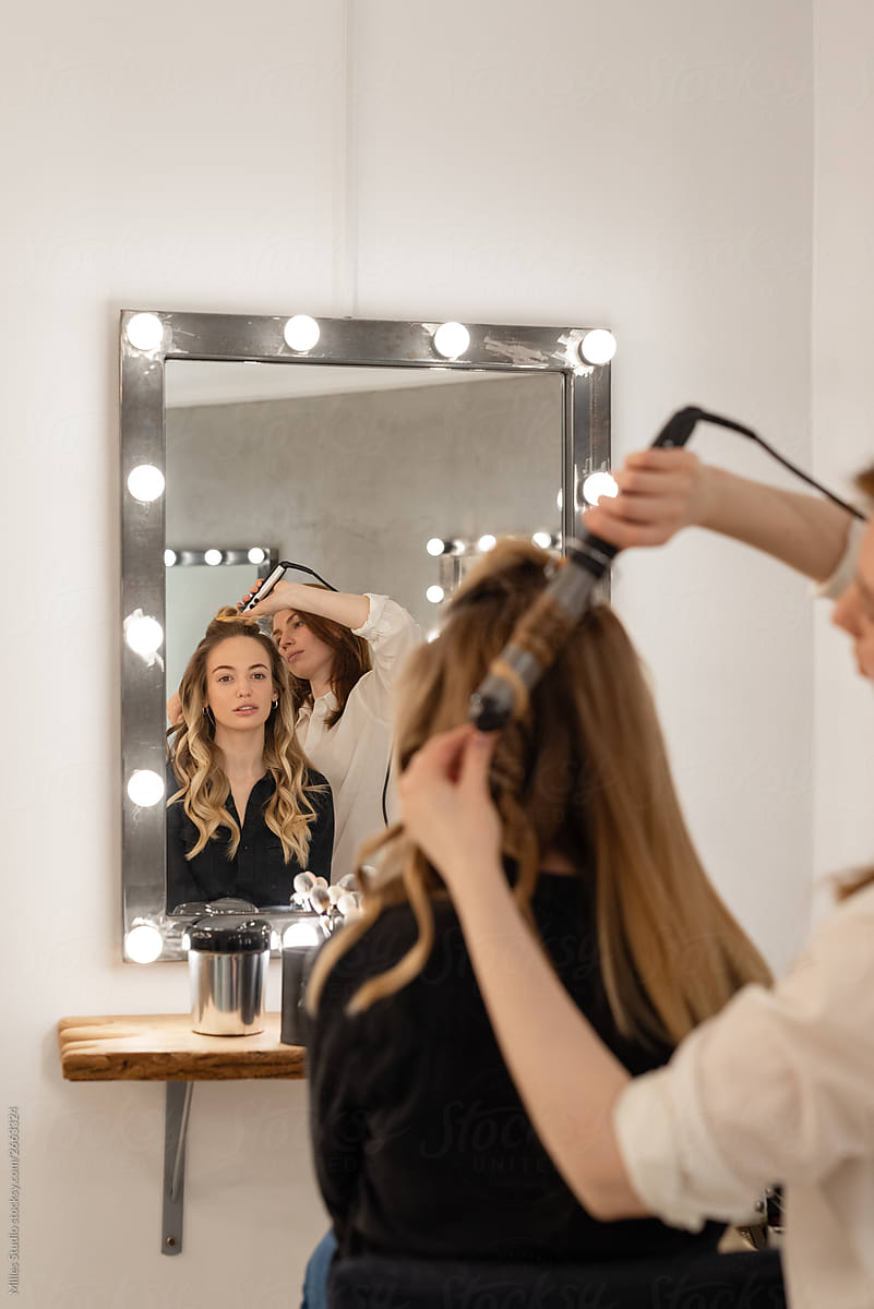 Crop Hairdresser Styling Hair Of Woman Near Mirror By Stocksy Contributor Milles Studio