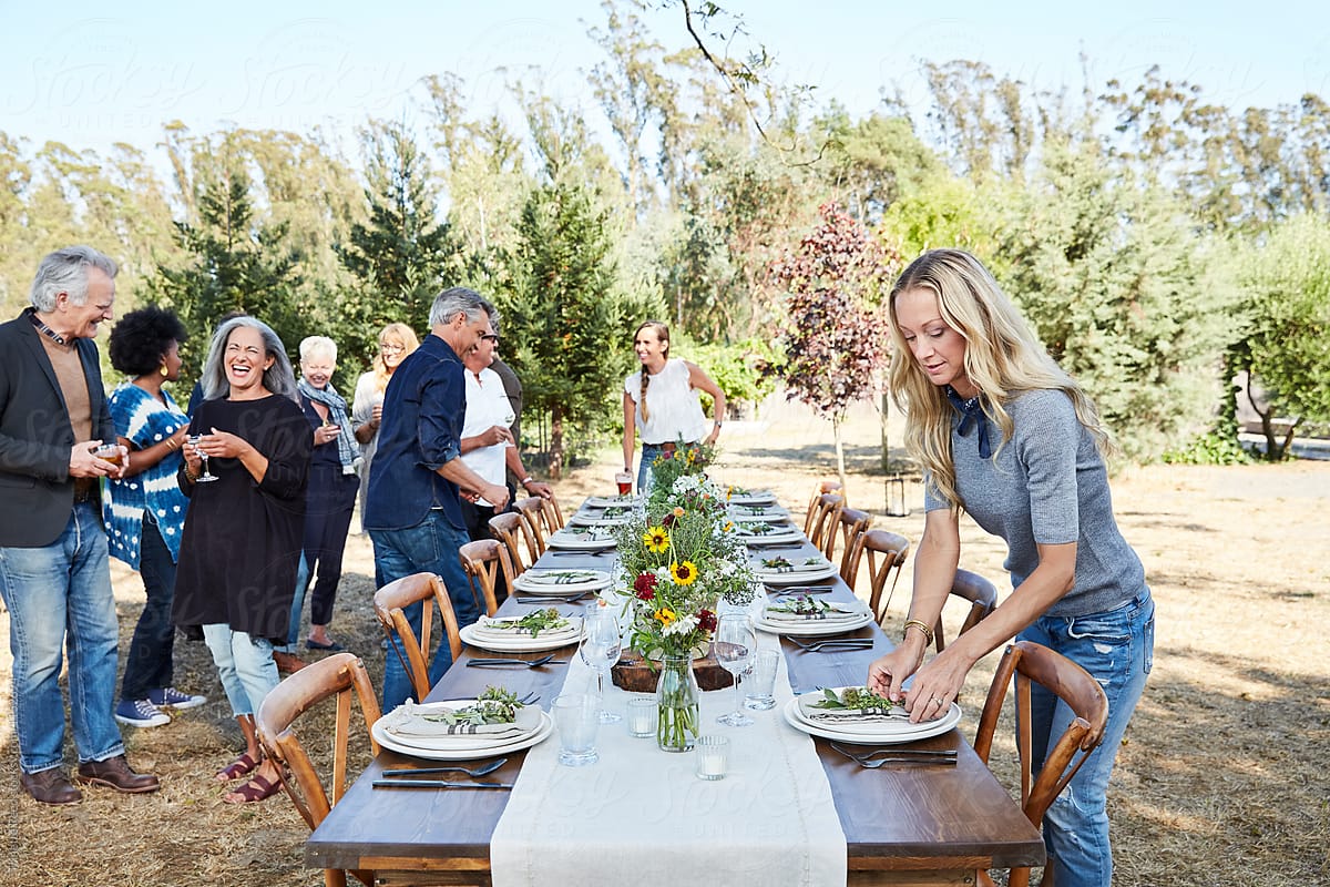 Mature couple setting the table for a farm to table dinner party