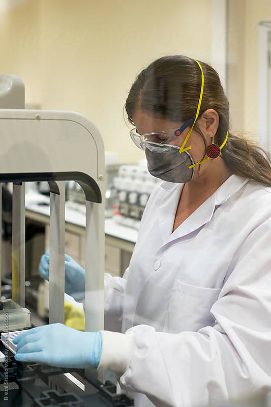 Female scientist working with a genome sequencing machine in a DNA laboratory