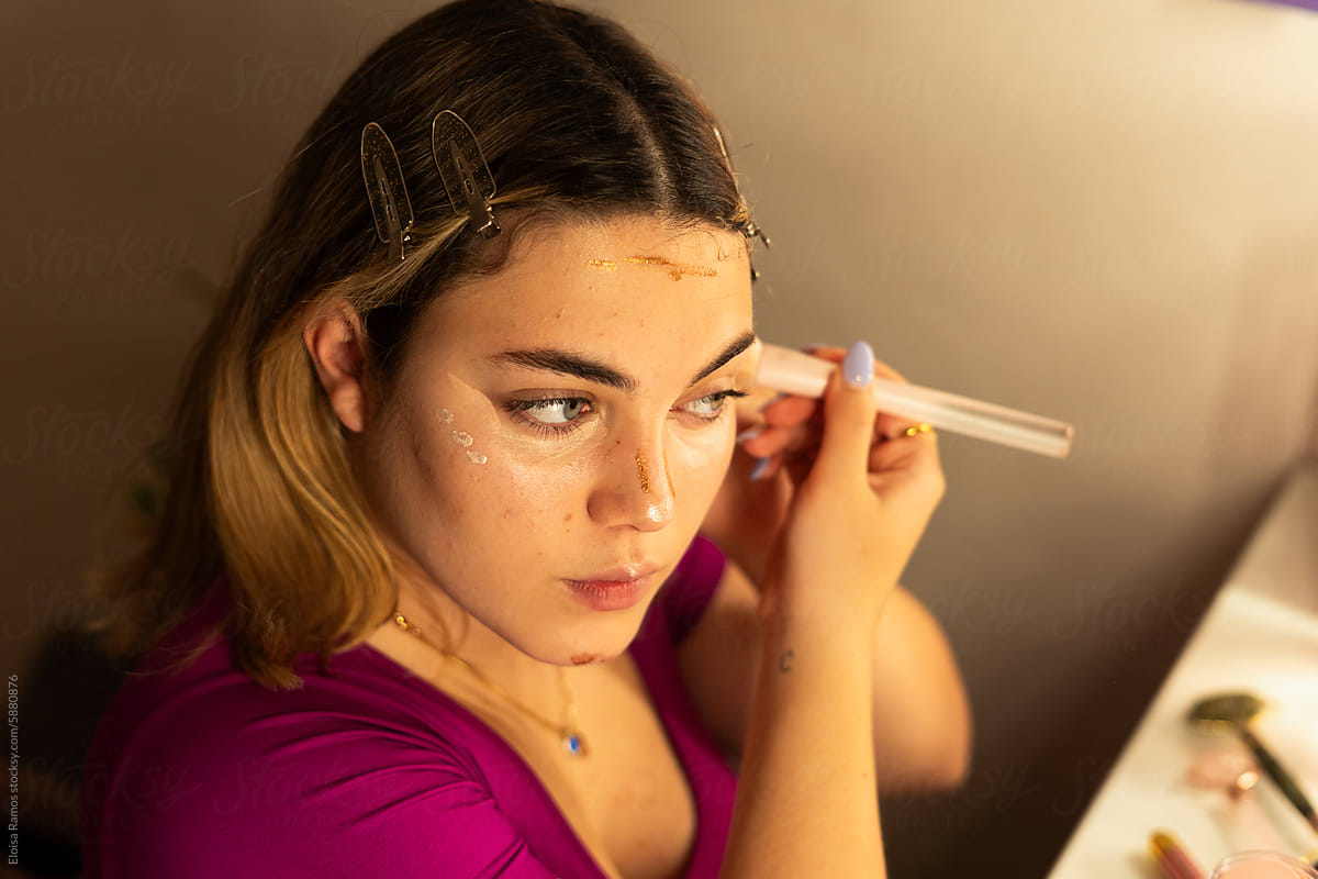 young  woman applying contouring makeup
