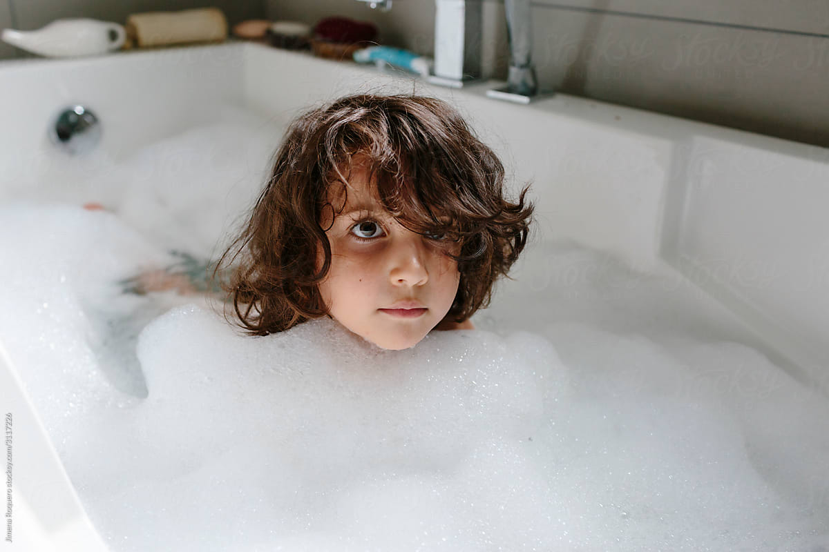 Kid having a foam bath