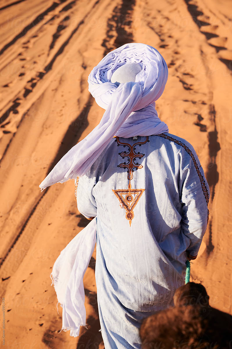 Anonymus guide walking dromedaries desert