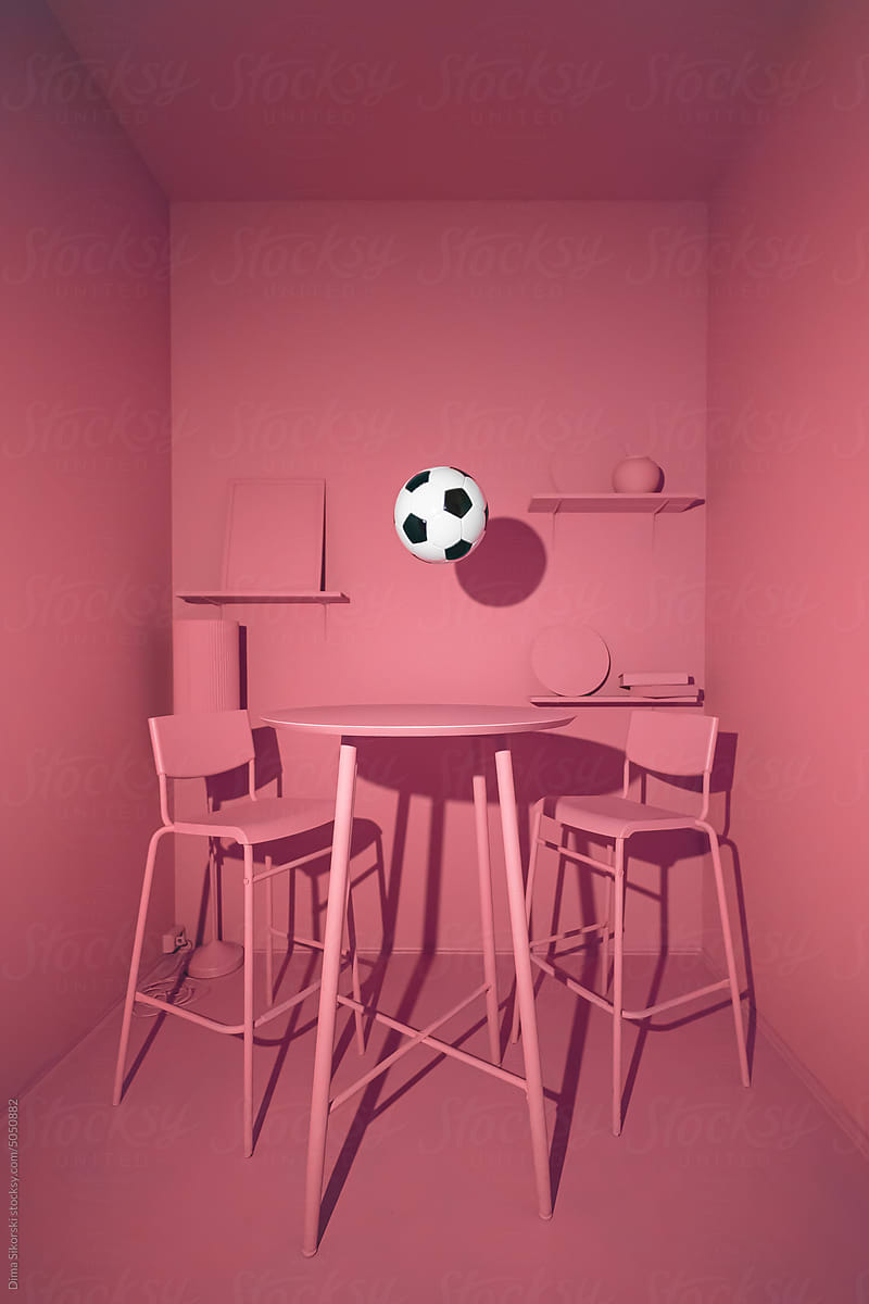 Creative still life with a soccer ball in a red monochrome interior