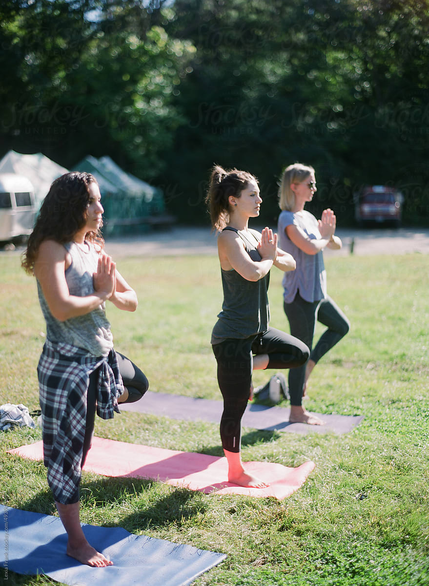 women doing yoga outside in the summer