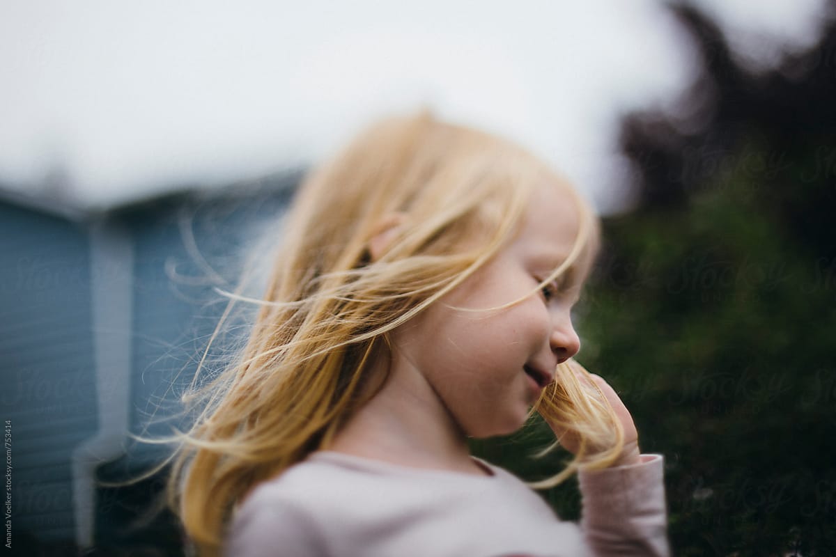 Windblown Profile Of A Young Girl With Strawberry Blonde Hair By