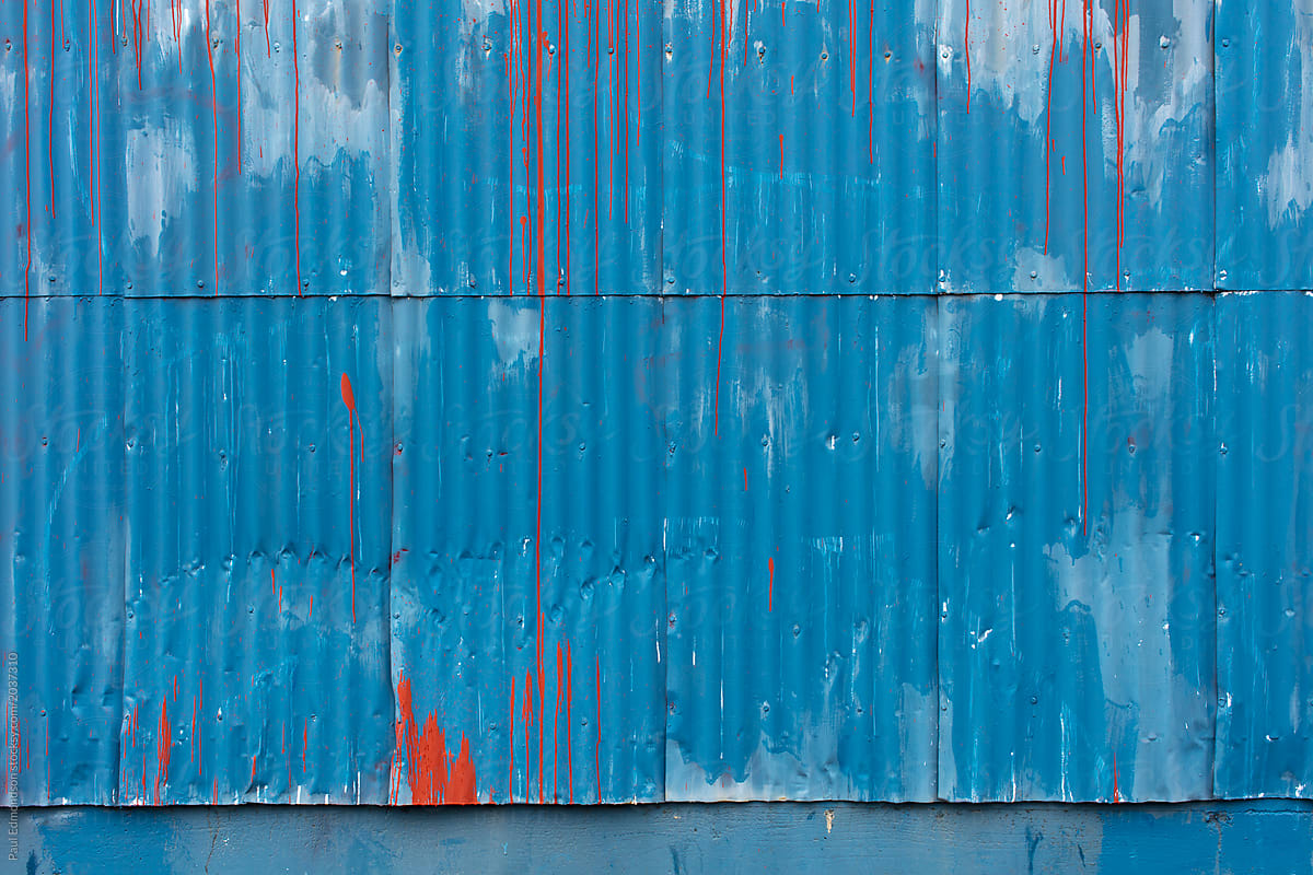 Dripping red paint on warehouse wall
