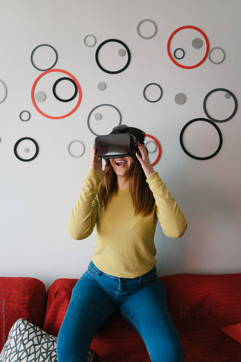 Happy woman in VR glasses at home