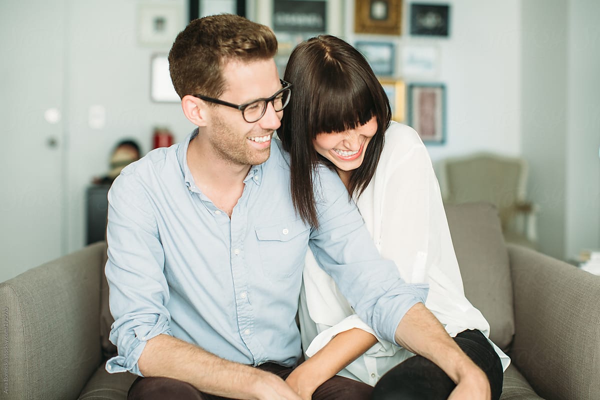 Happy Couple Laughing Together At Home By Stocksy Contributor A Model Photographer Stocksy