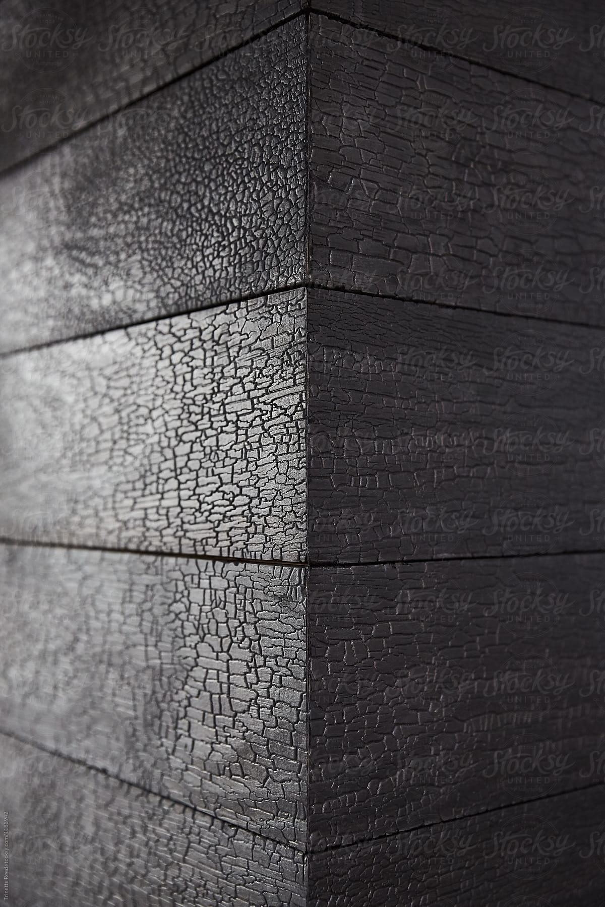 Close-up detail of Japanese Charred wood Shou Sugi Ban on fireplace hearth