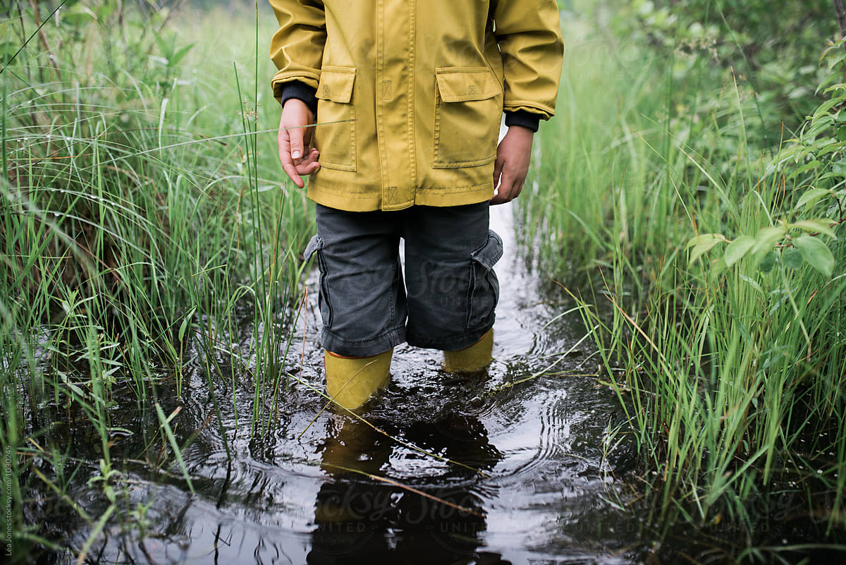 little boy on walk in a flooded path