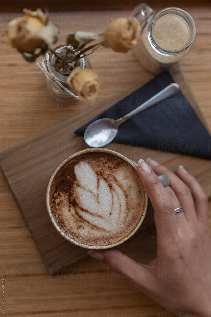 Elegant Female Hand and Cappuccino
