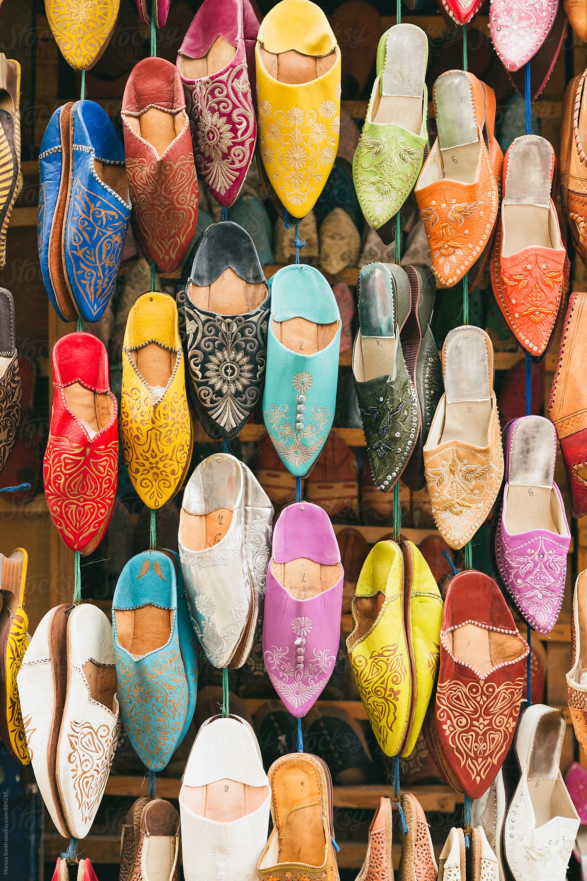 Colourful Moroccan slippers hanging at a market stall