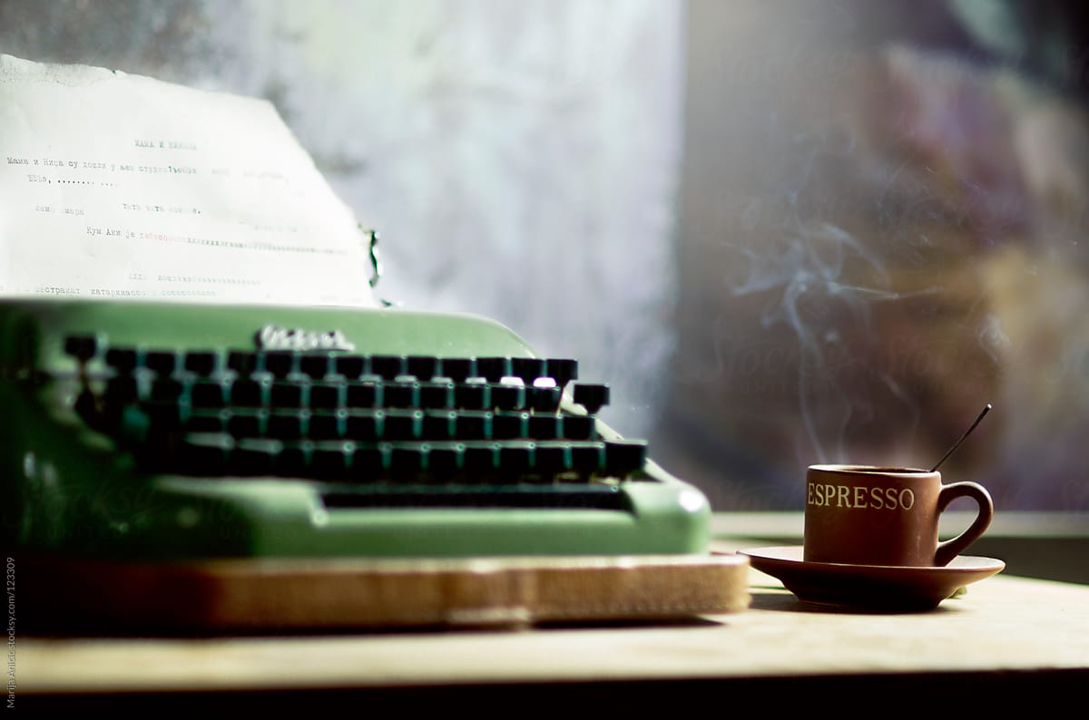 Vintage typewriter and coffee on wooden desk
