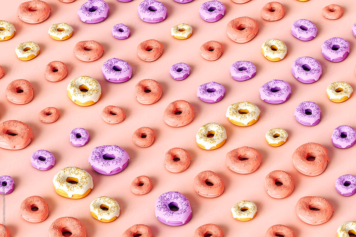a lot of colorful donuts on pink background