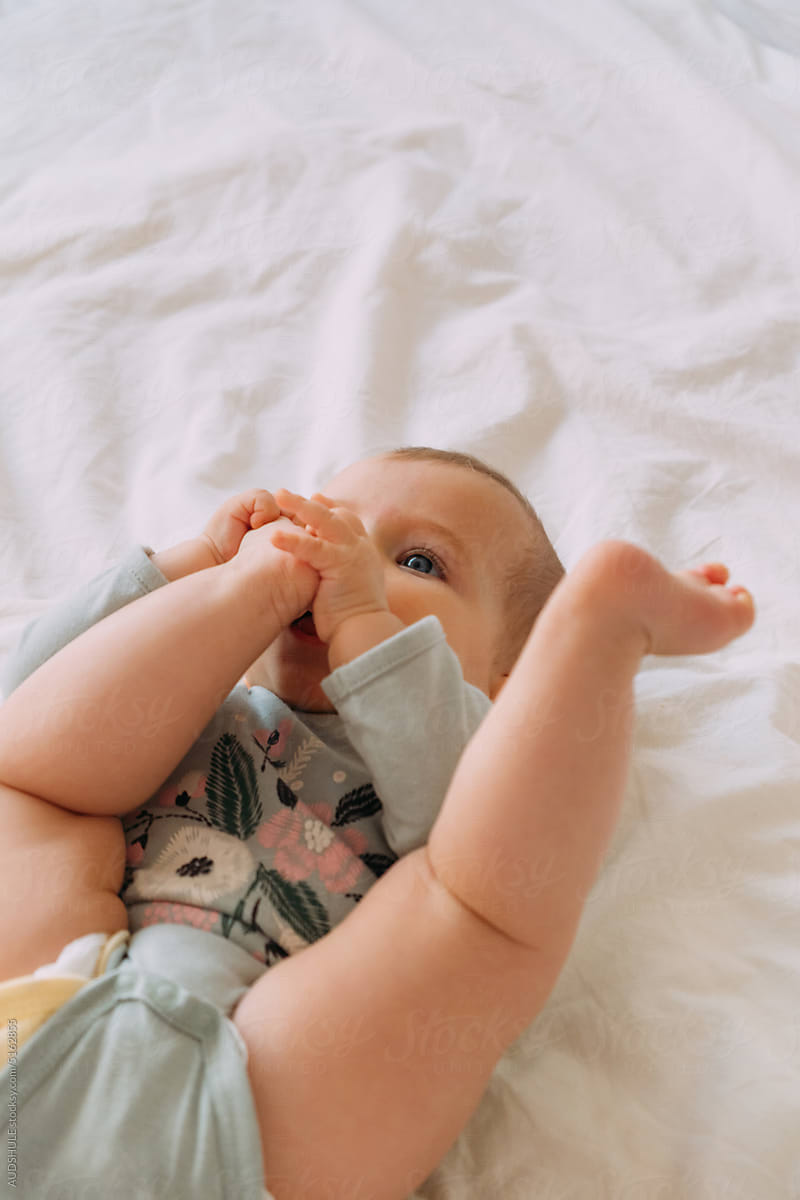 Baby putting feet in mouth.
