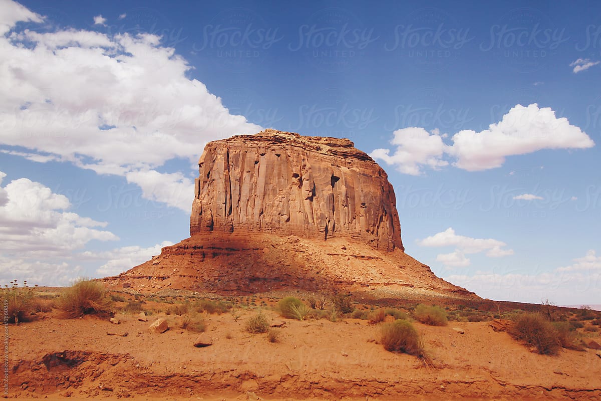 Sunrays shining down on Monument Valley\'s characteristic, iconic butte landscape.