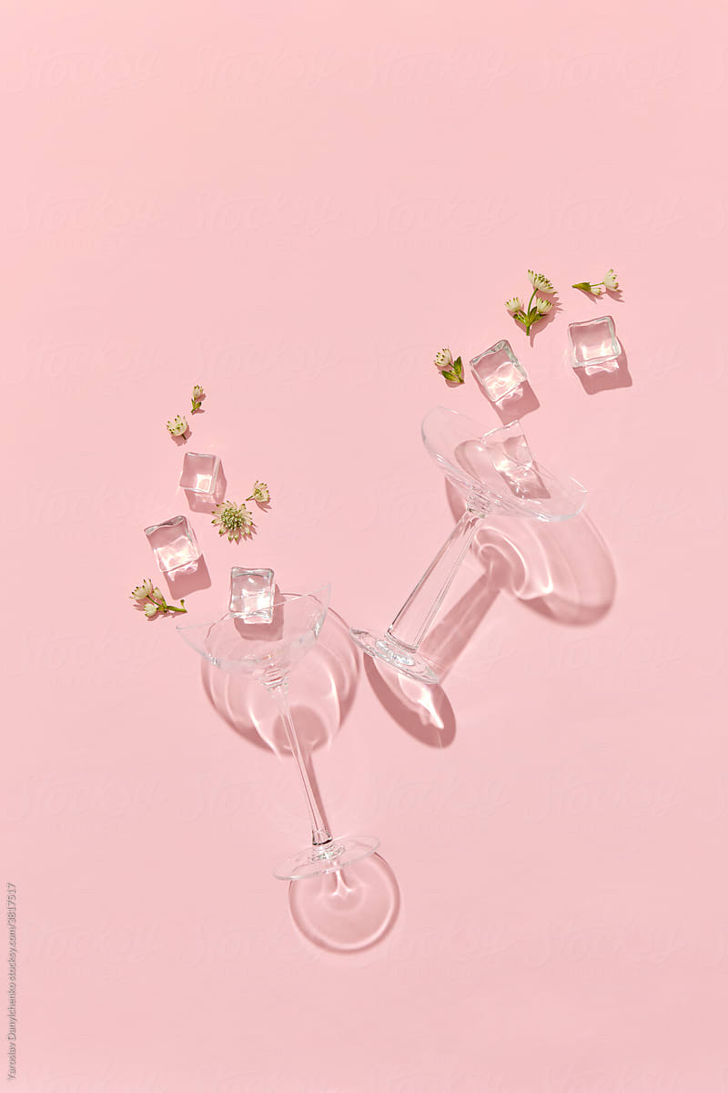Scattered glasses, ice cubes and flowers