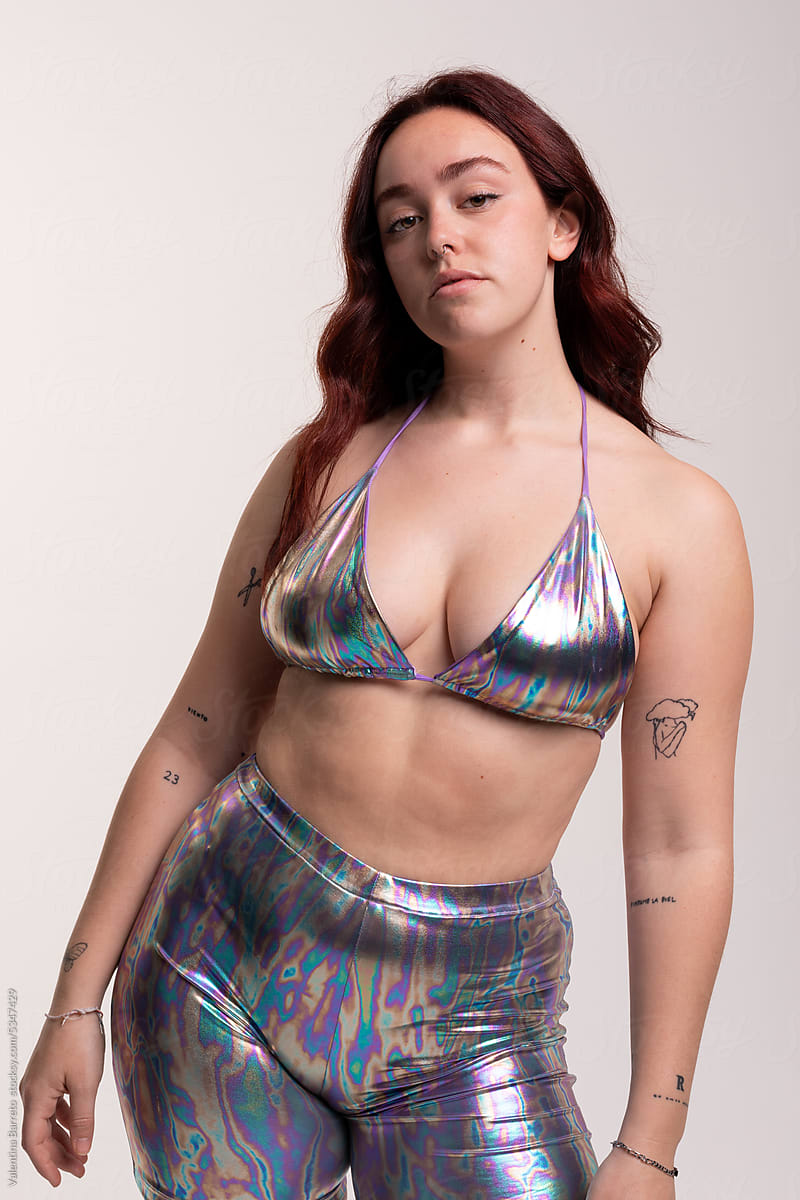 Curvy woman posing with bright holographic look