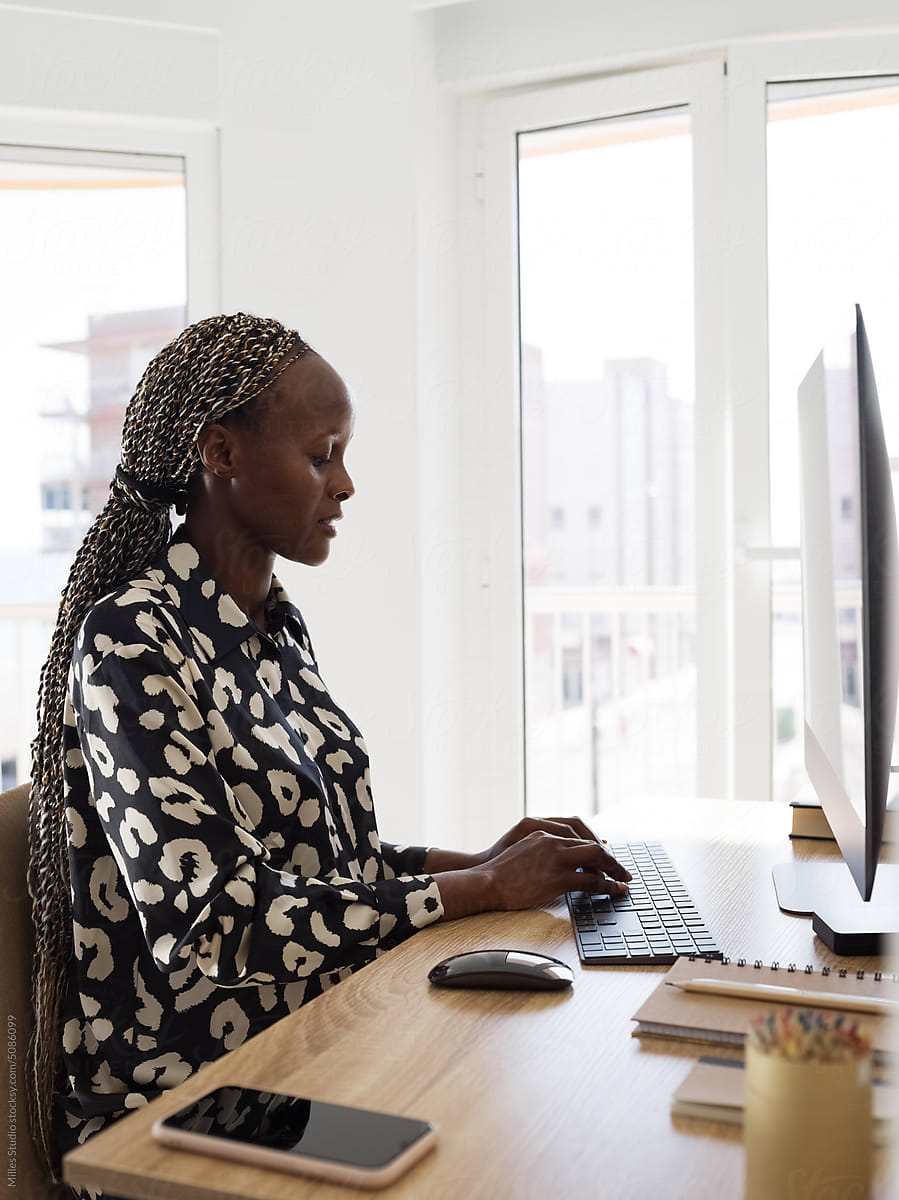 Concentrated black businesswoman working online
