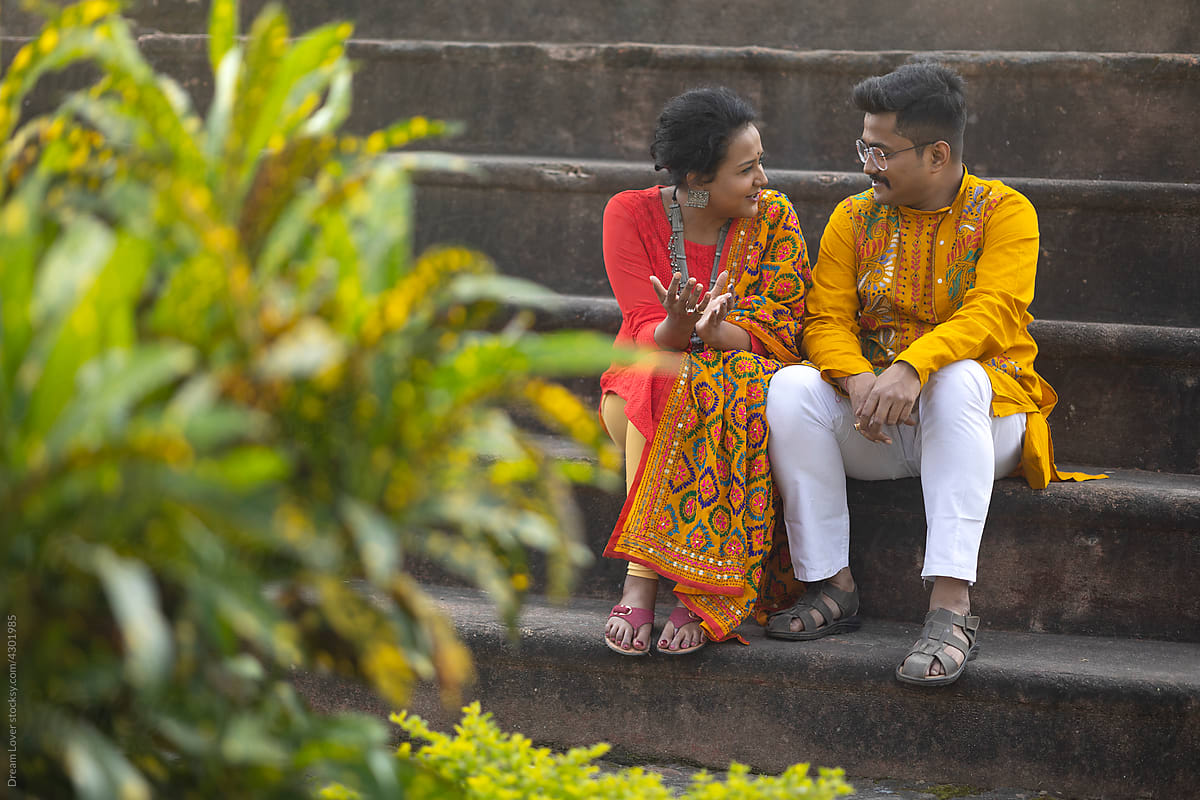 A Couple wearing traditional dress interacting at outdoor