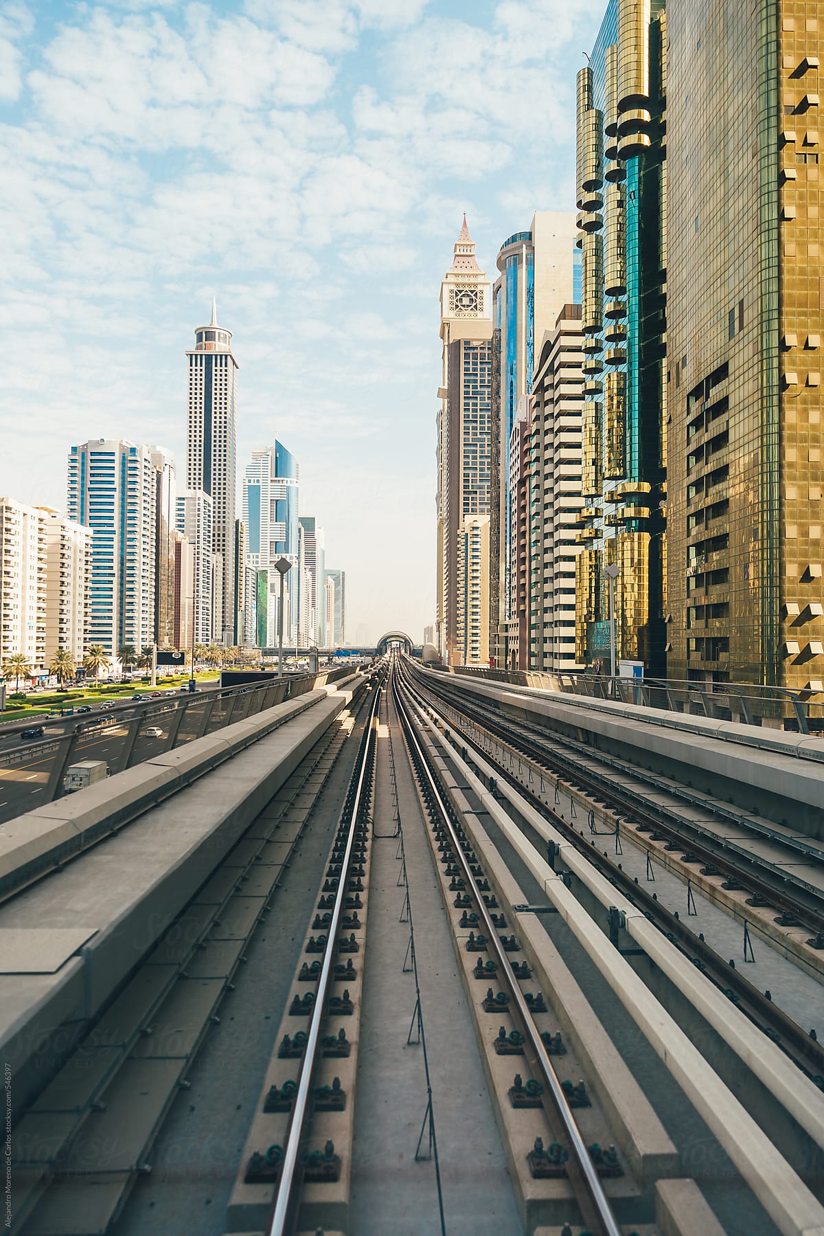 Railway and city buildings view in Dubai metro rail network. Dubai, United Arab Emirates
