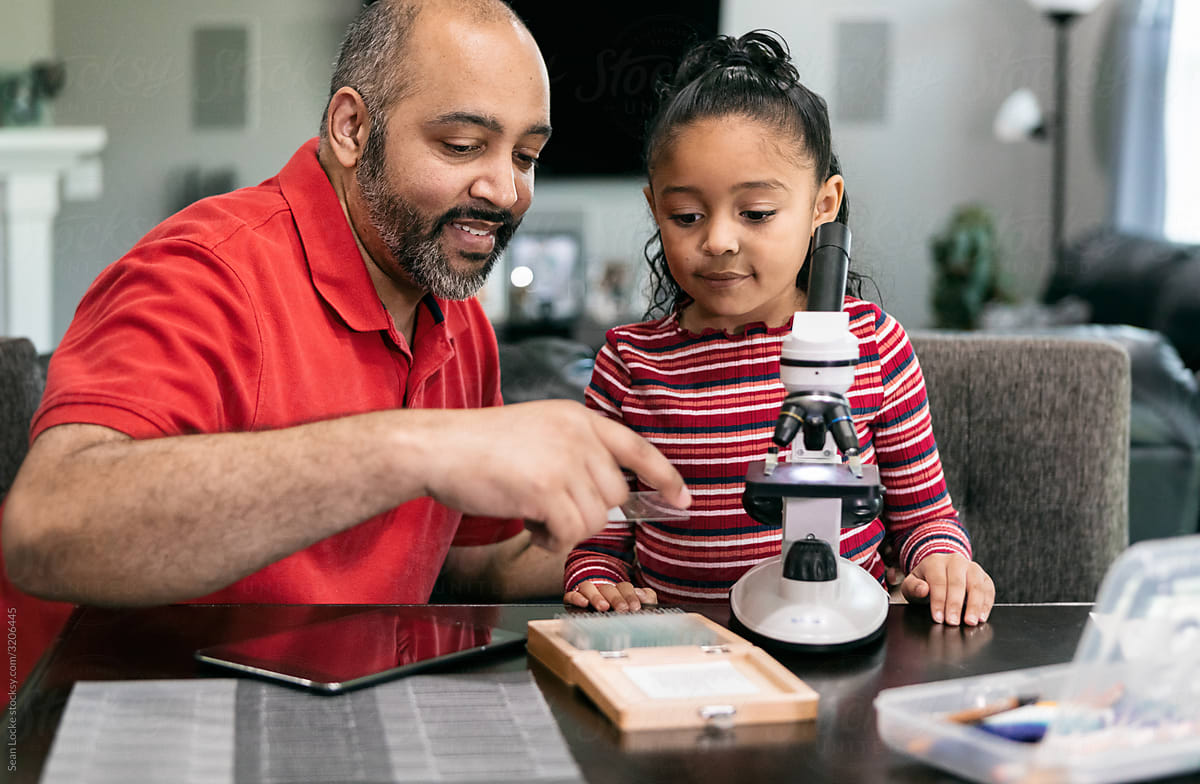 Home: Dad Helps Girl With Microscope While Homeschooling During