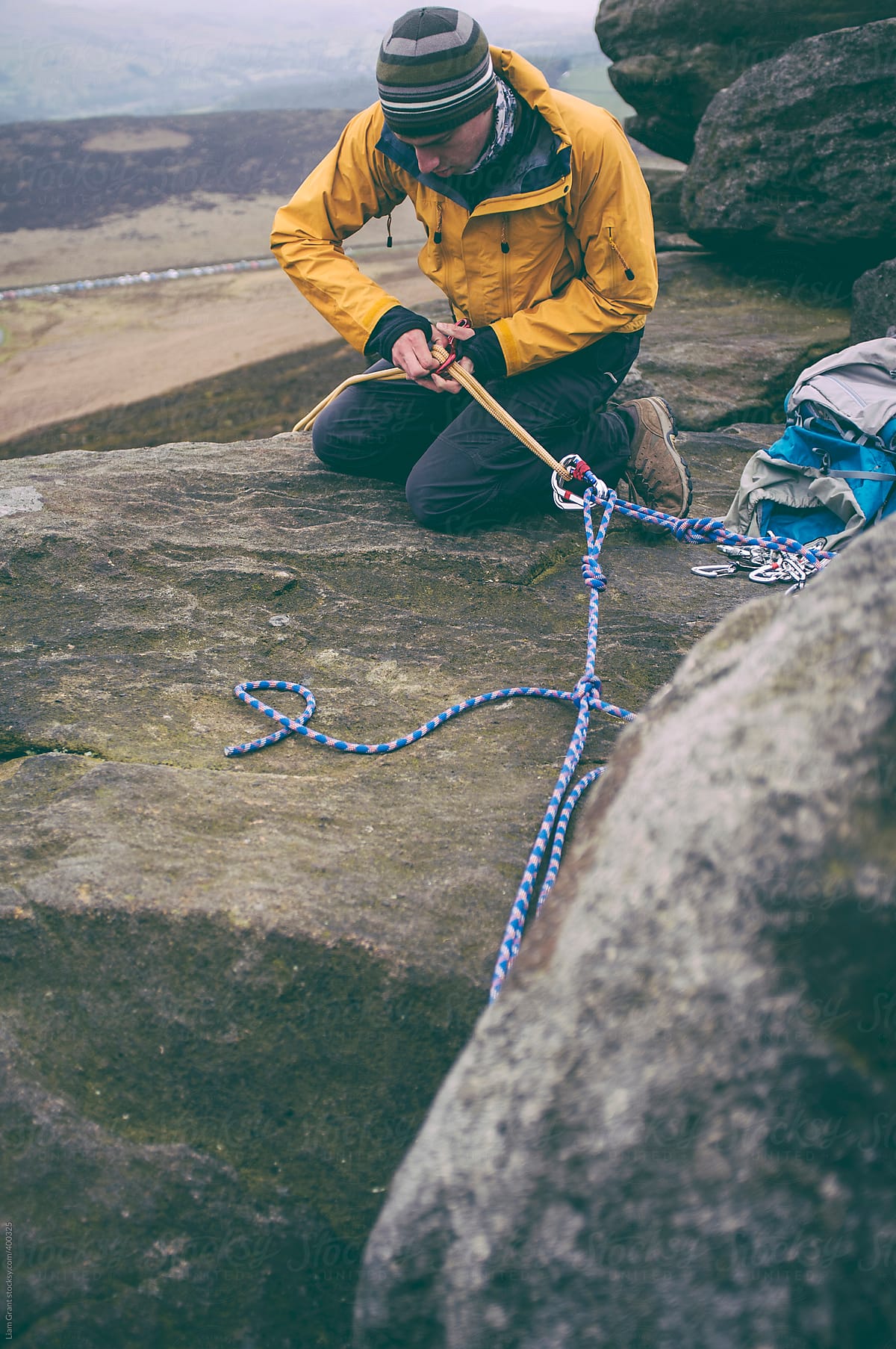 Climber setting up rope for abseiling.