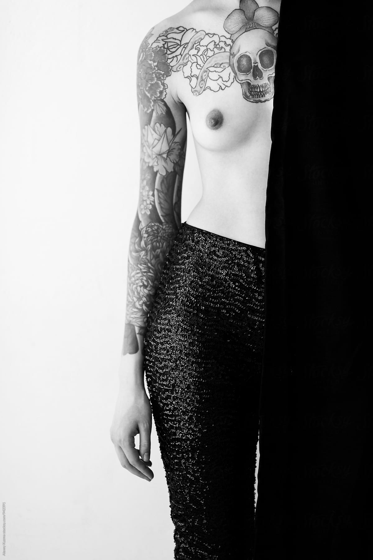 topless young woman with tattoo