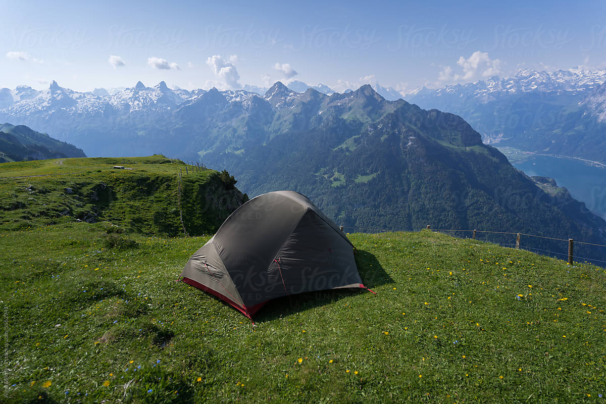 Camping Tent Against Mountain Range In Swiss Alps