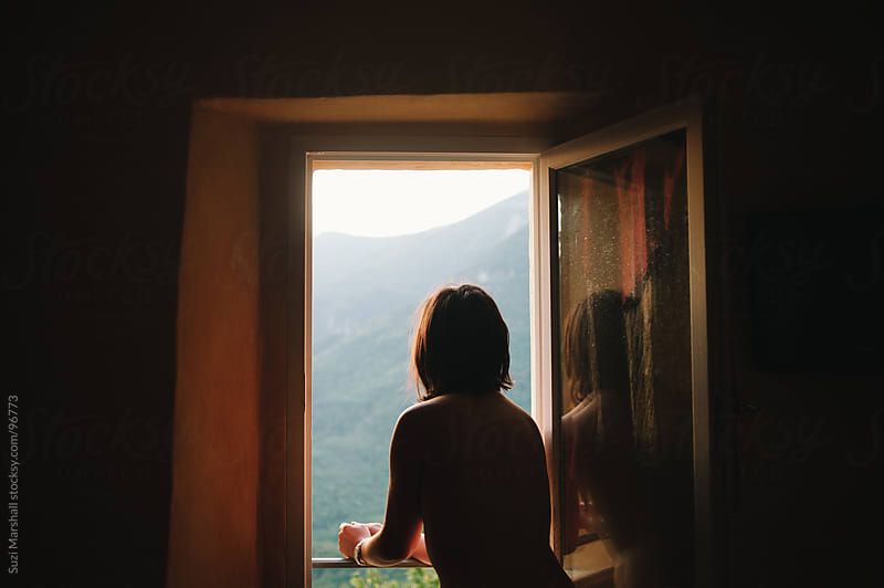 Woman standing at an open window watching the sunrise by Suzi Marshall ... Open Window At Morning