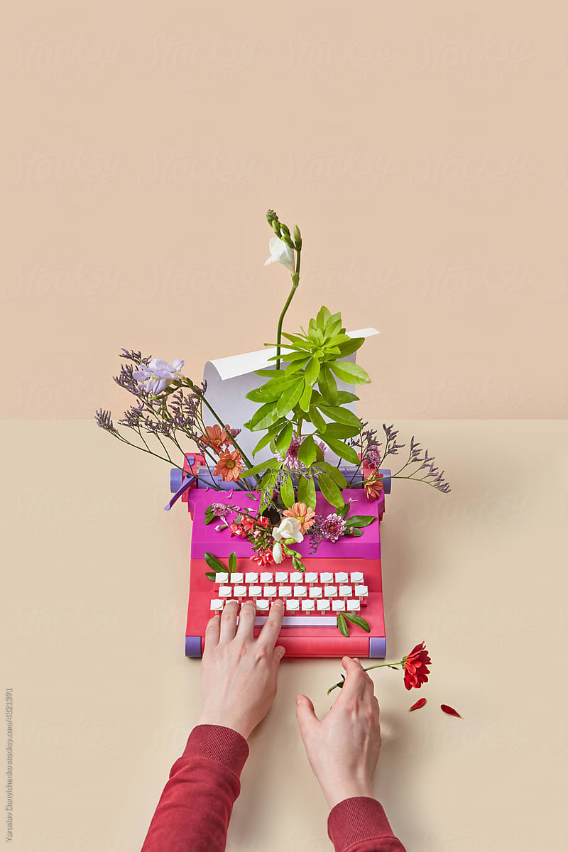 Man using typewriter decorated with flowers