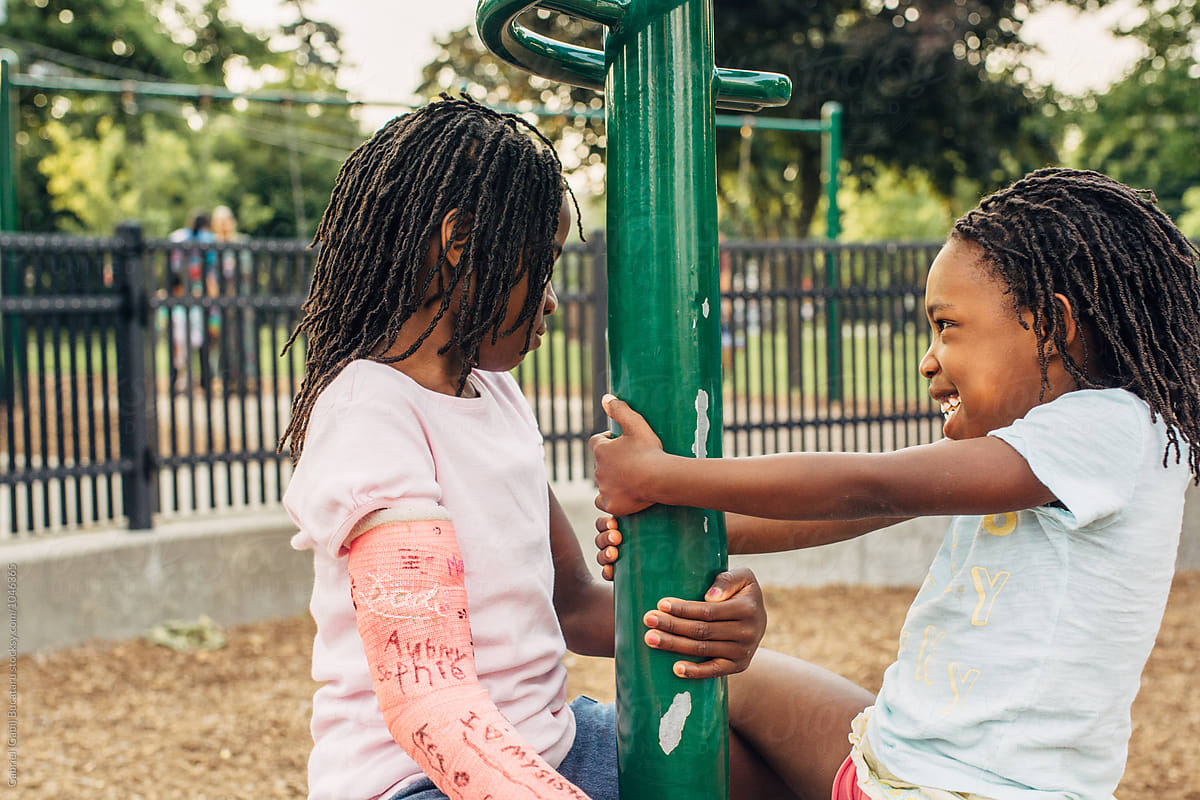 Two black girls playing in a park
