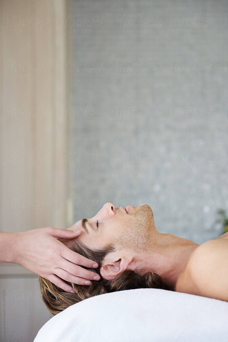 Man receiving a scalp massage at luxury spa