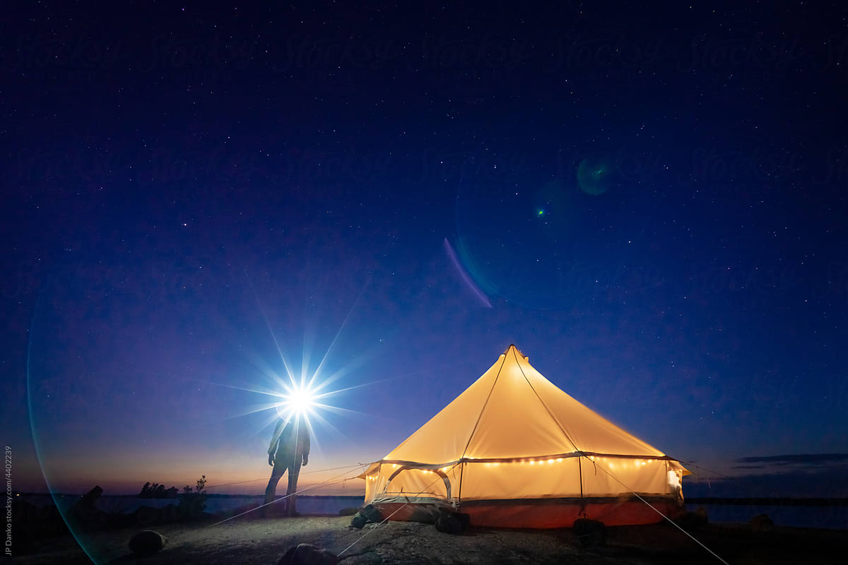 Man Looking at Night Sky on Wilderness Island Campsite