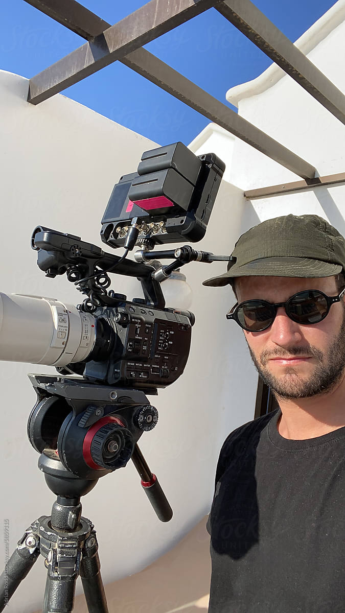 Selfie of a professional videographer with his video equipment