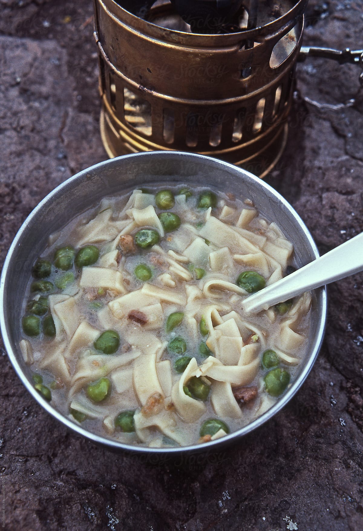 closeup backpacking camping meal cooked on backpacking stove peas noodles