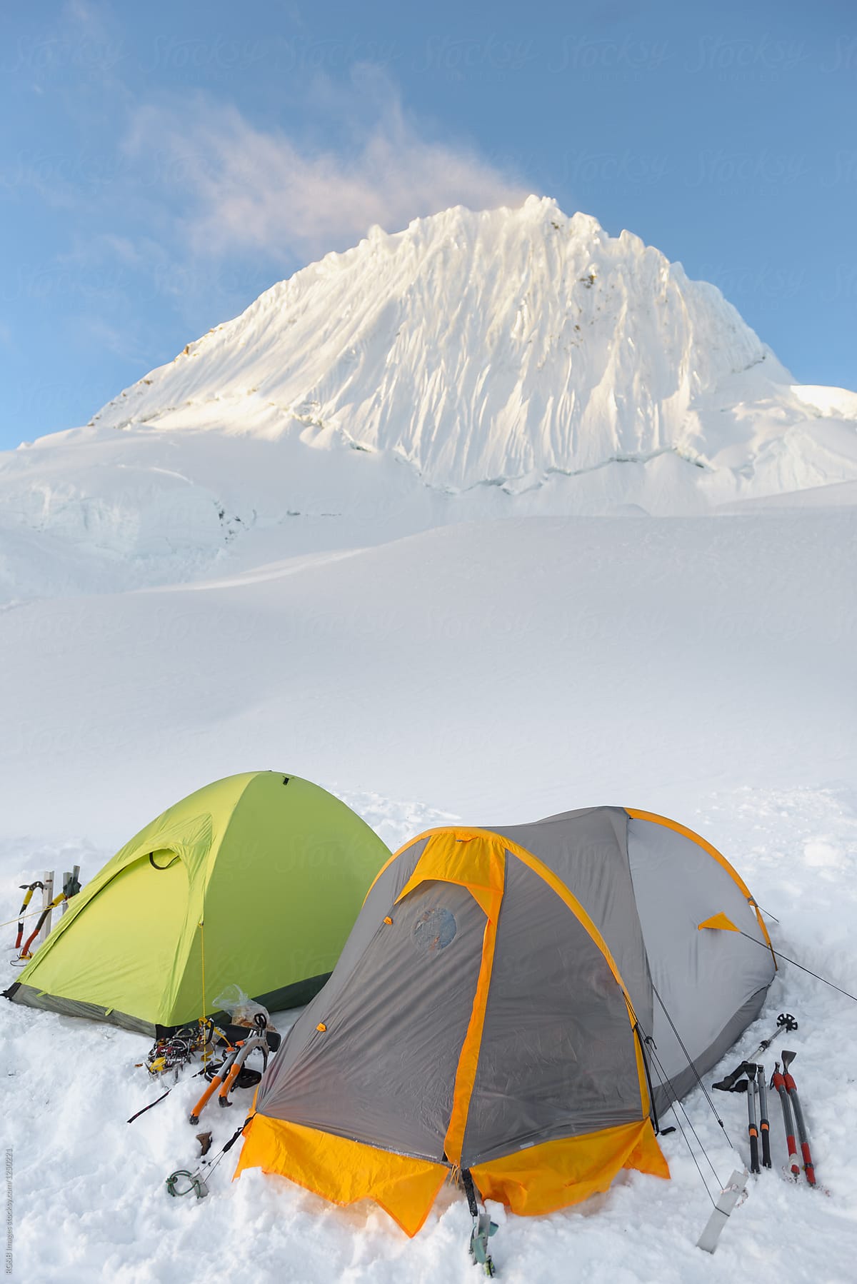 Tents settled on mountain plateau covered by powdery snow