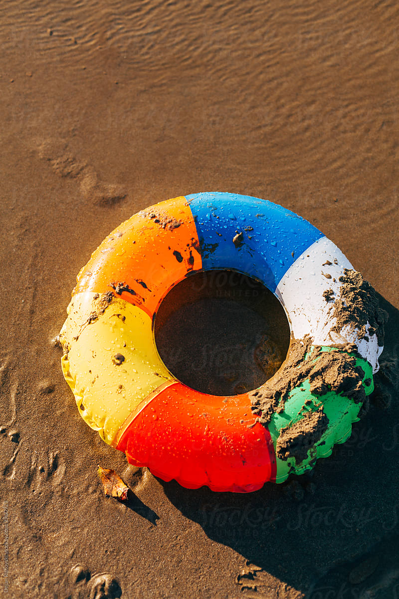 Colorful inflatable belt on a sand