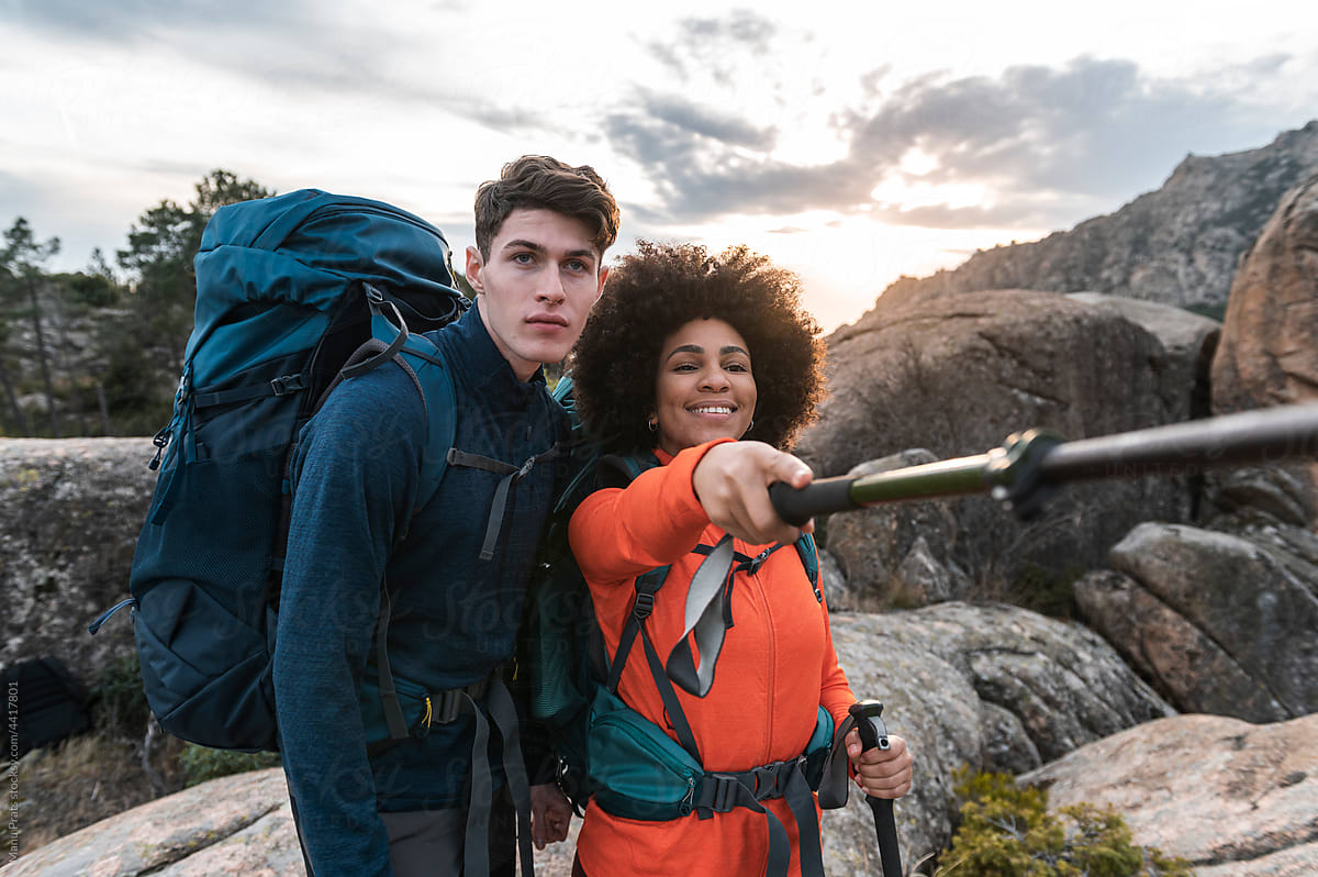 Diverse hikers using hiking pole to explore mountains
