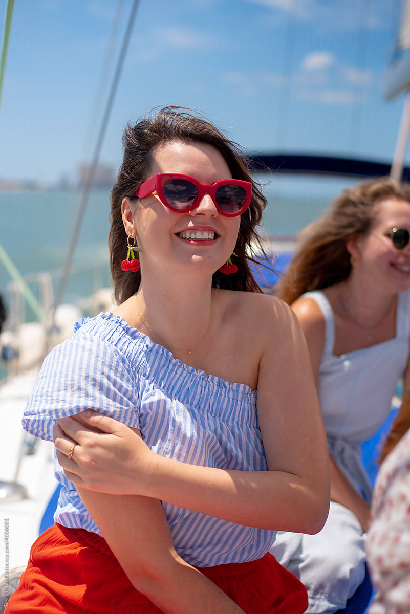 Young happy woman portrait with red sunglasses