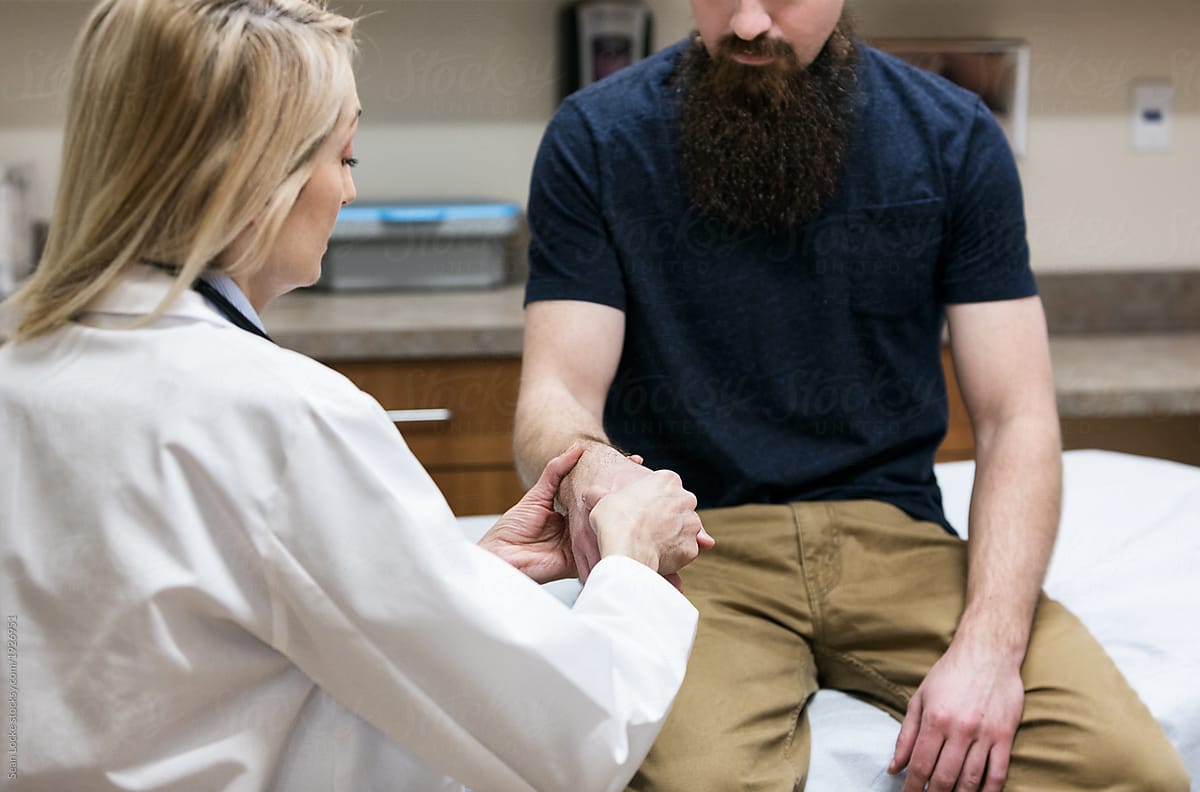Clinic: Doctor Examines Man's Wrist Injury