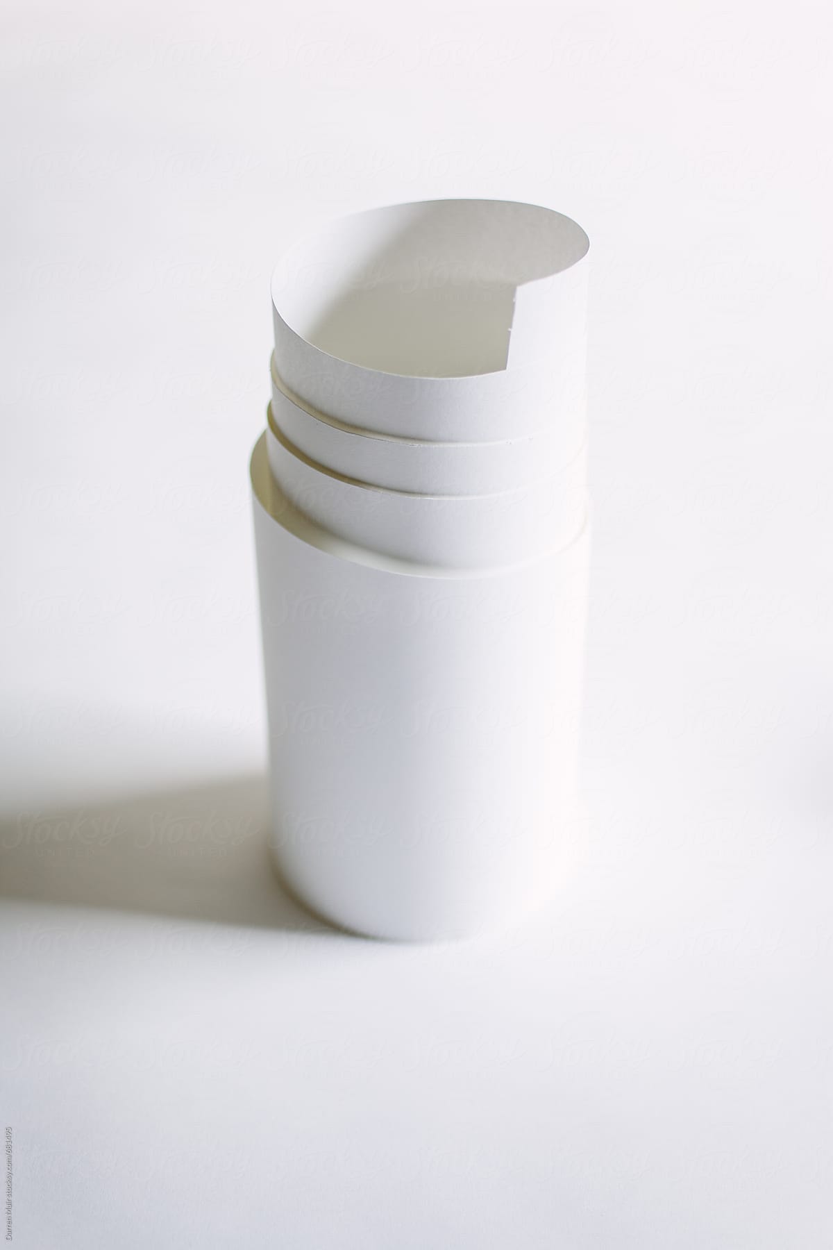 A roll of white paper on a white background.