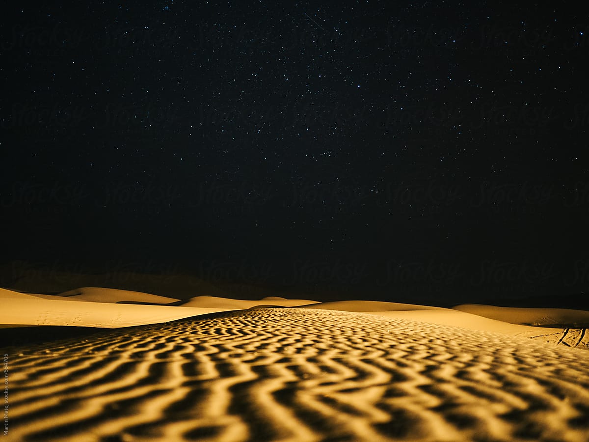 Lines in the sand leading to a sky full of starts