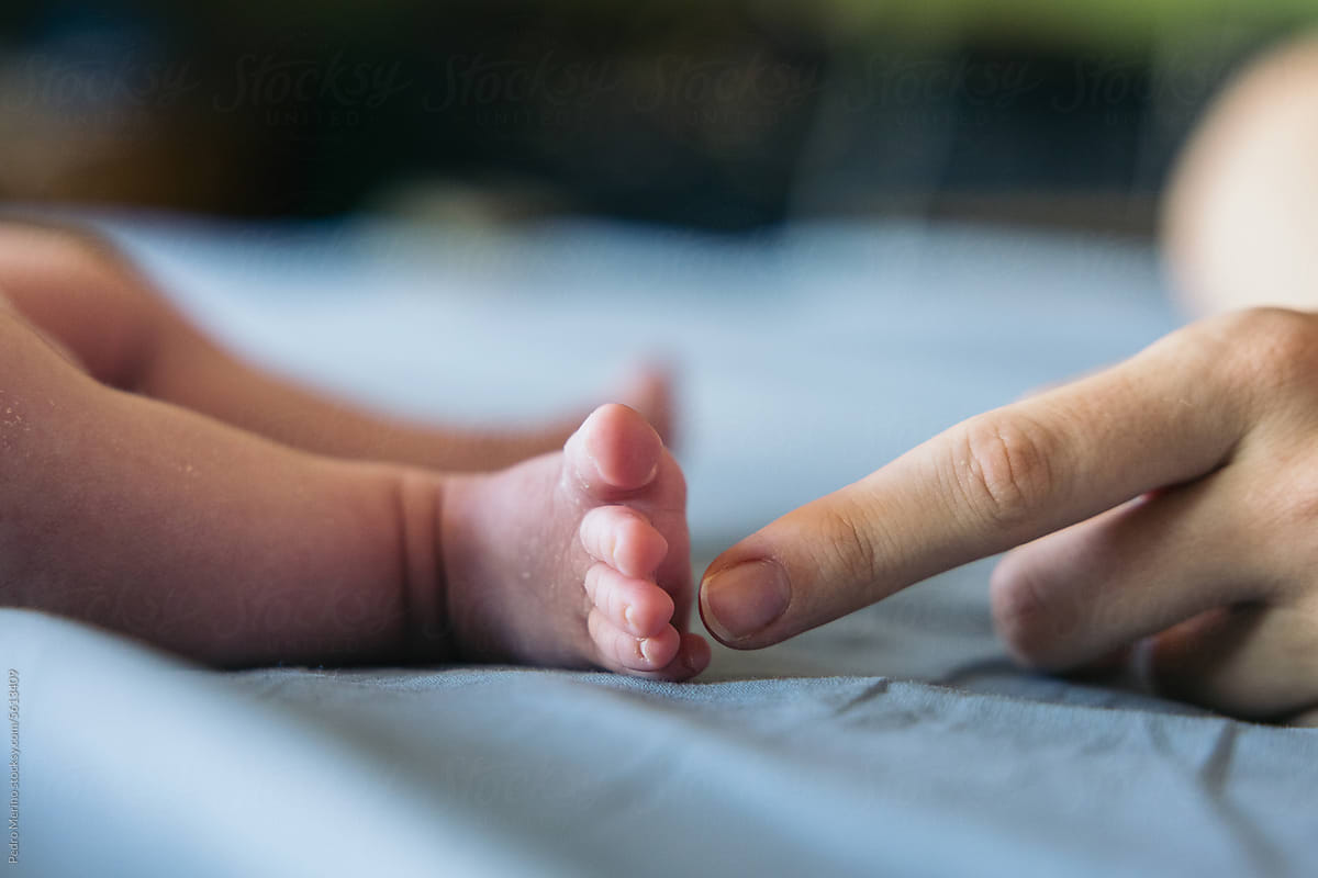 Close-up of the tiny feet of a newborn baby.