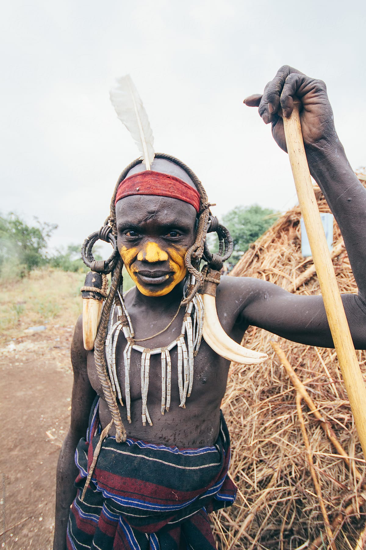 Mursi tribe man with traditional clothes and wood cane. Mago National park, Ethiopia, Africa